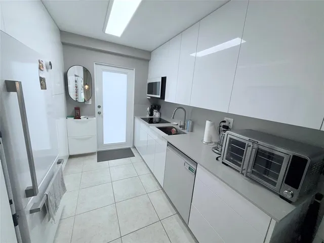 a kitchen with a refrigerator and a stove top oven