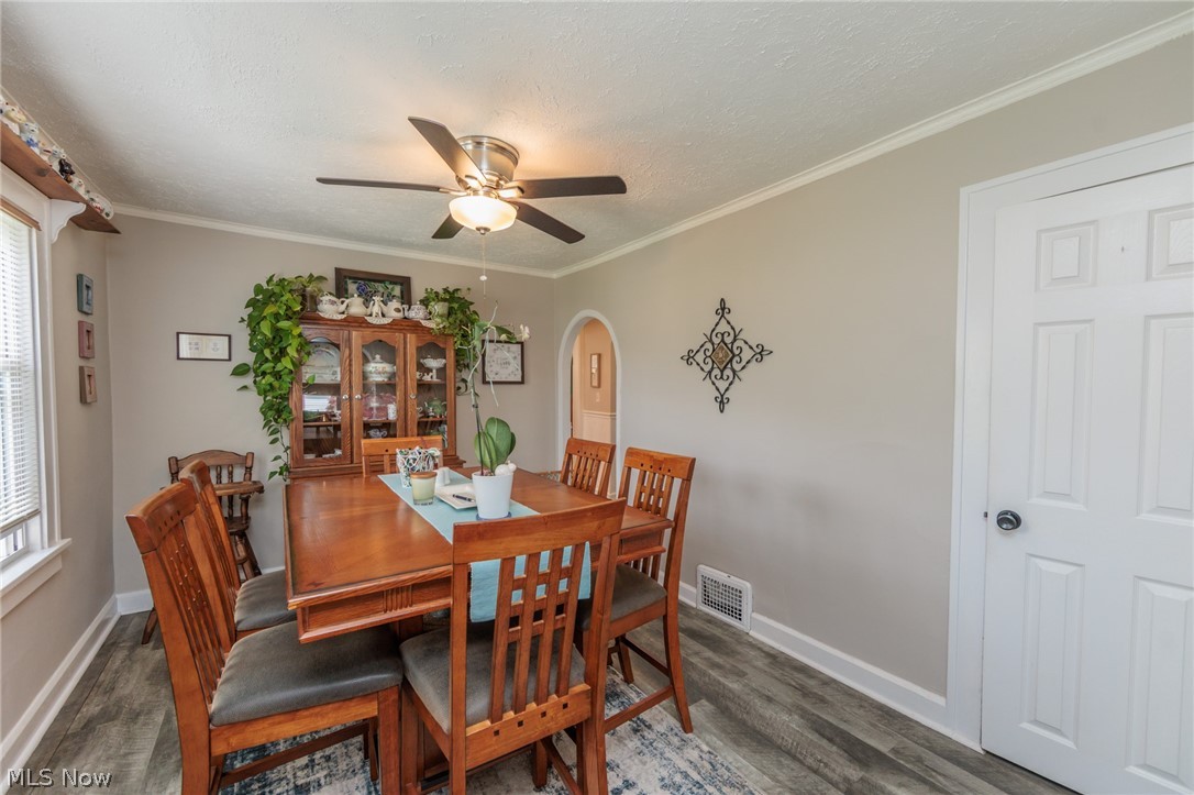 5364 Summit Road Lyndhurst, OH 44124 - Photo 10 of 42 Dining area featuring wood-finish flooring, a ceiling fan with integrated lighting, and crown molding