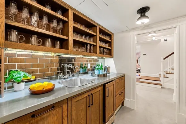 a kitchen with a sink and a potted plant