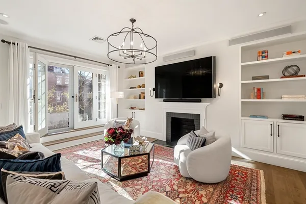 a living room with furniture fireplace and flat screen tv