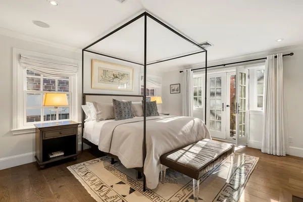 a bedroom with a bed window and table