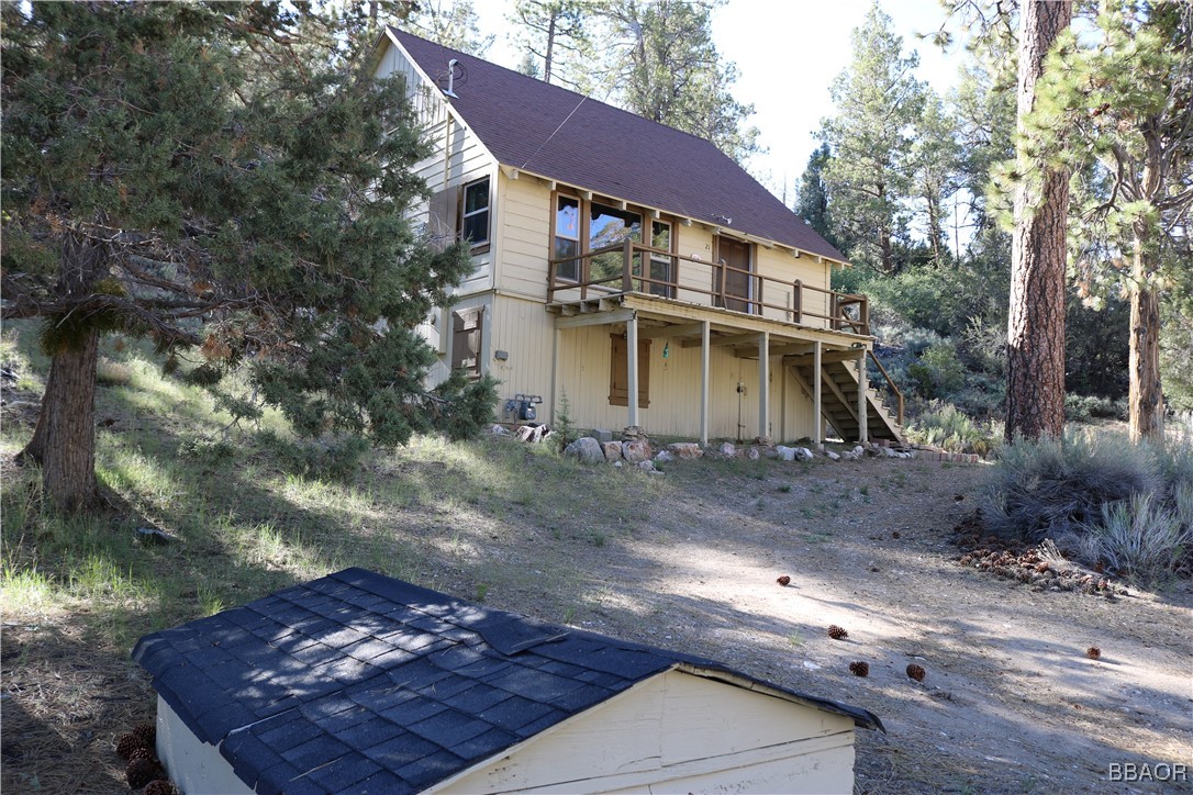 21 Holcomb Valley Road Fawnskin, CA 92333 - Photo 13 of 24 Below the cabin on the east side is an in-ground well with well house and pump; potable water. No water bill