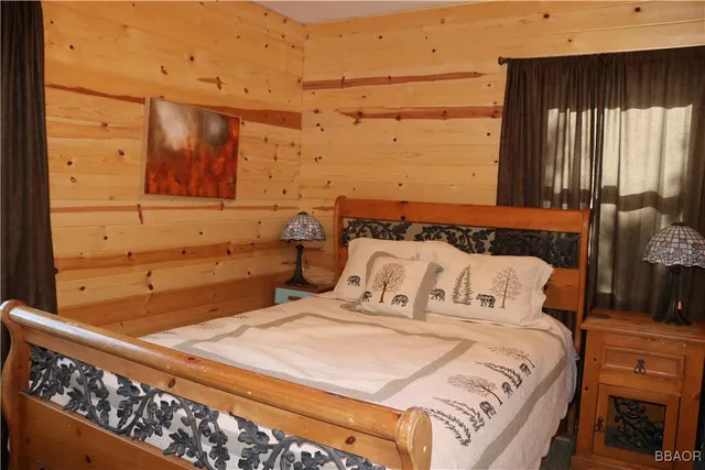 a bed sitting in a bedroom next to a window