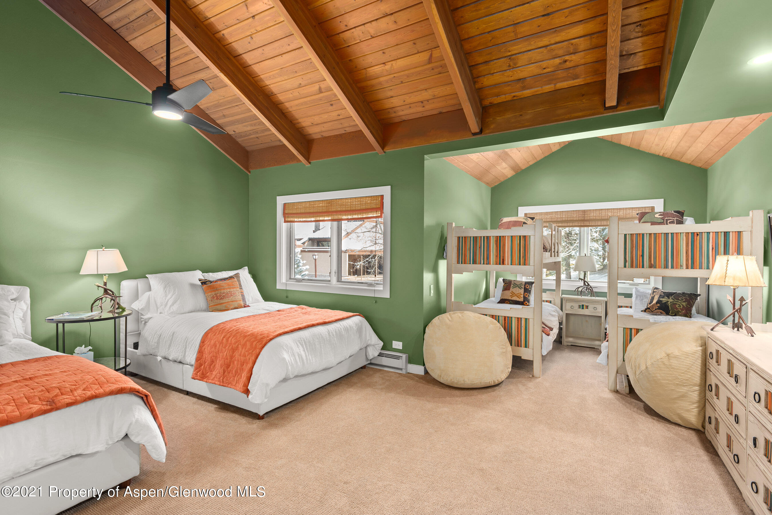 810 Ridge Road, Unit 2 Snowmass Village, CO 81615 - Photo 11 of 31 a spacious bedroom with two beds and a chandelier