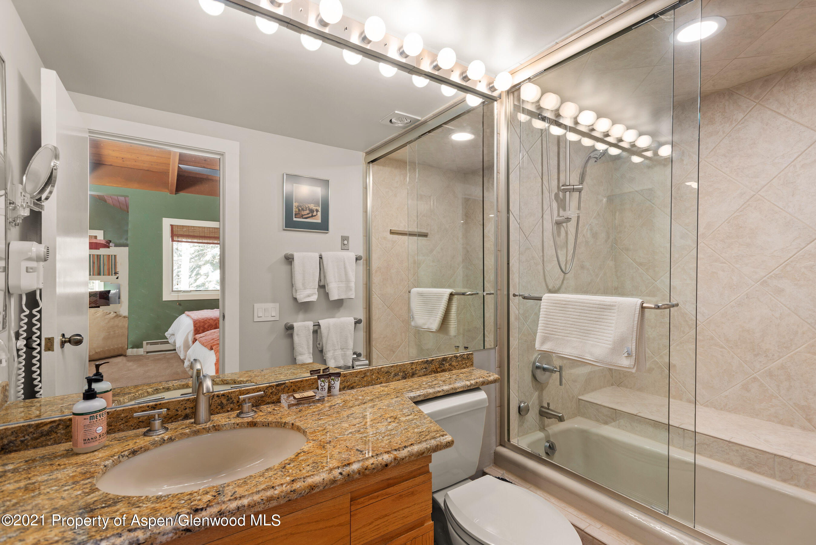 810 Ridge Road, Unit 2 Snowmass Village, CO 81615 - Photo 12 of 31 a bathroom with a granite countertop sink toilet mirror and shower