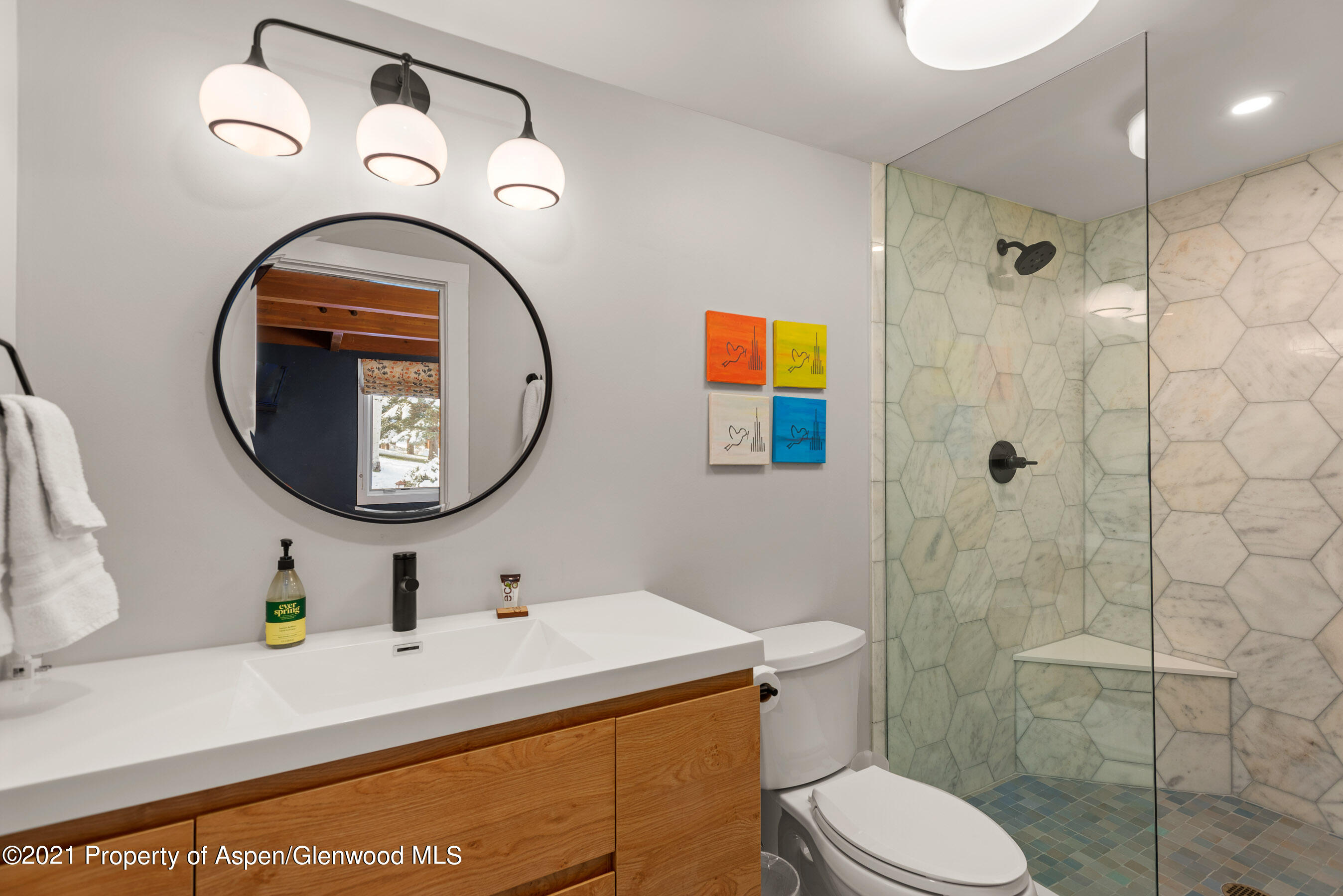 810 Ridge Road, Unit 2 Snowmass Village, CO 81615 - Photo 14 of 31 a bathroom with a toilet sink vanity and mirror