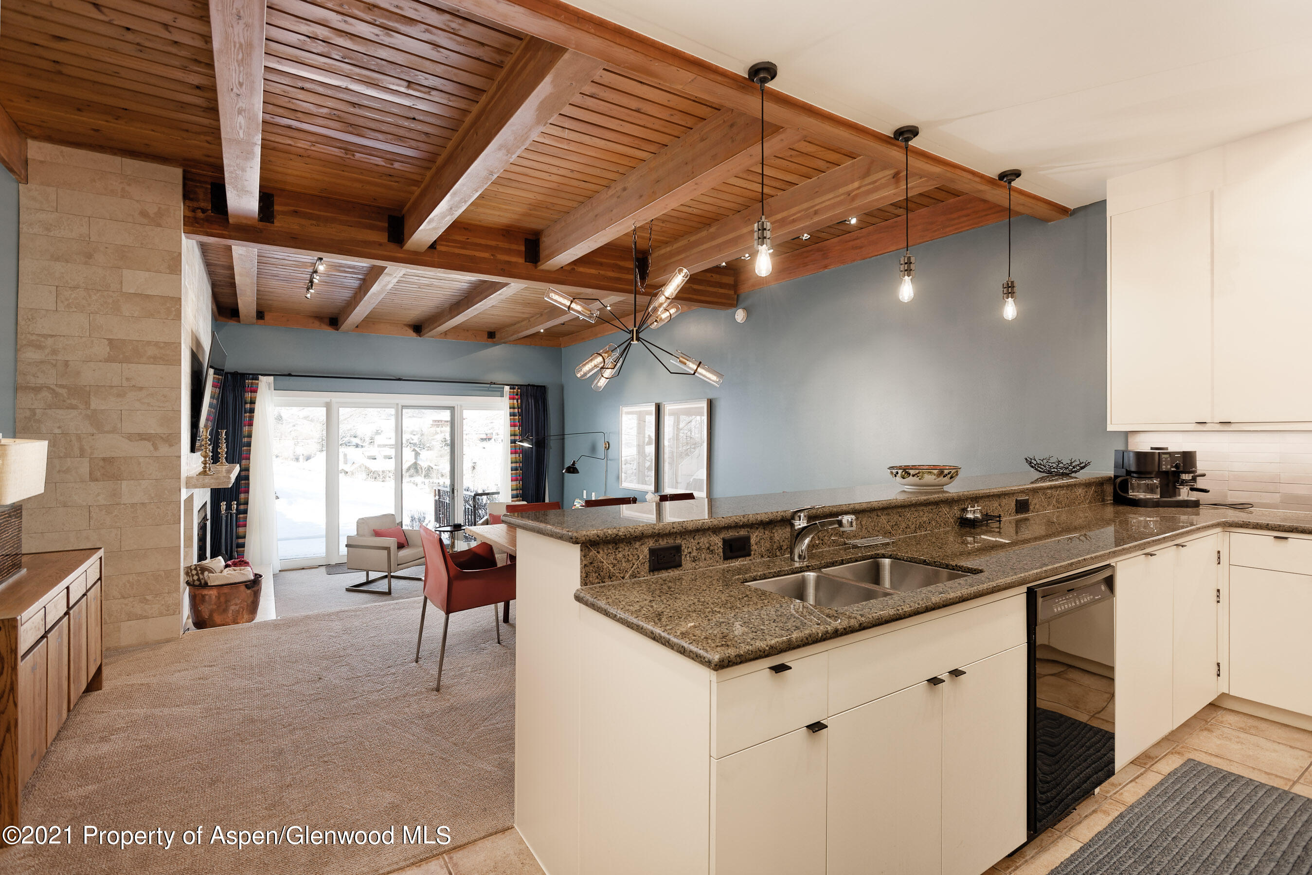 810 Ridge Road, Unit 2 Snowmass Village, CO 81615 - Photo 7 of 31 a kitchen with granite countertop a sink and stove