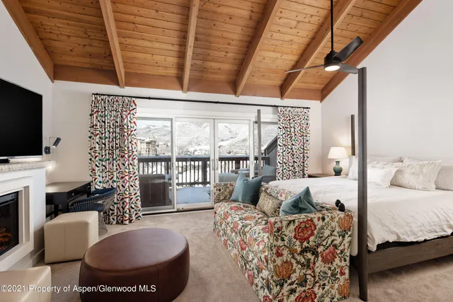 a living room with furniture a flat screen tv and a large window