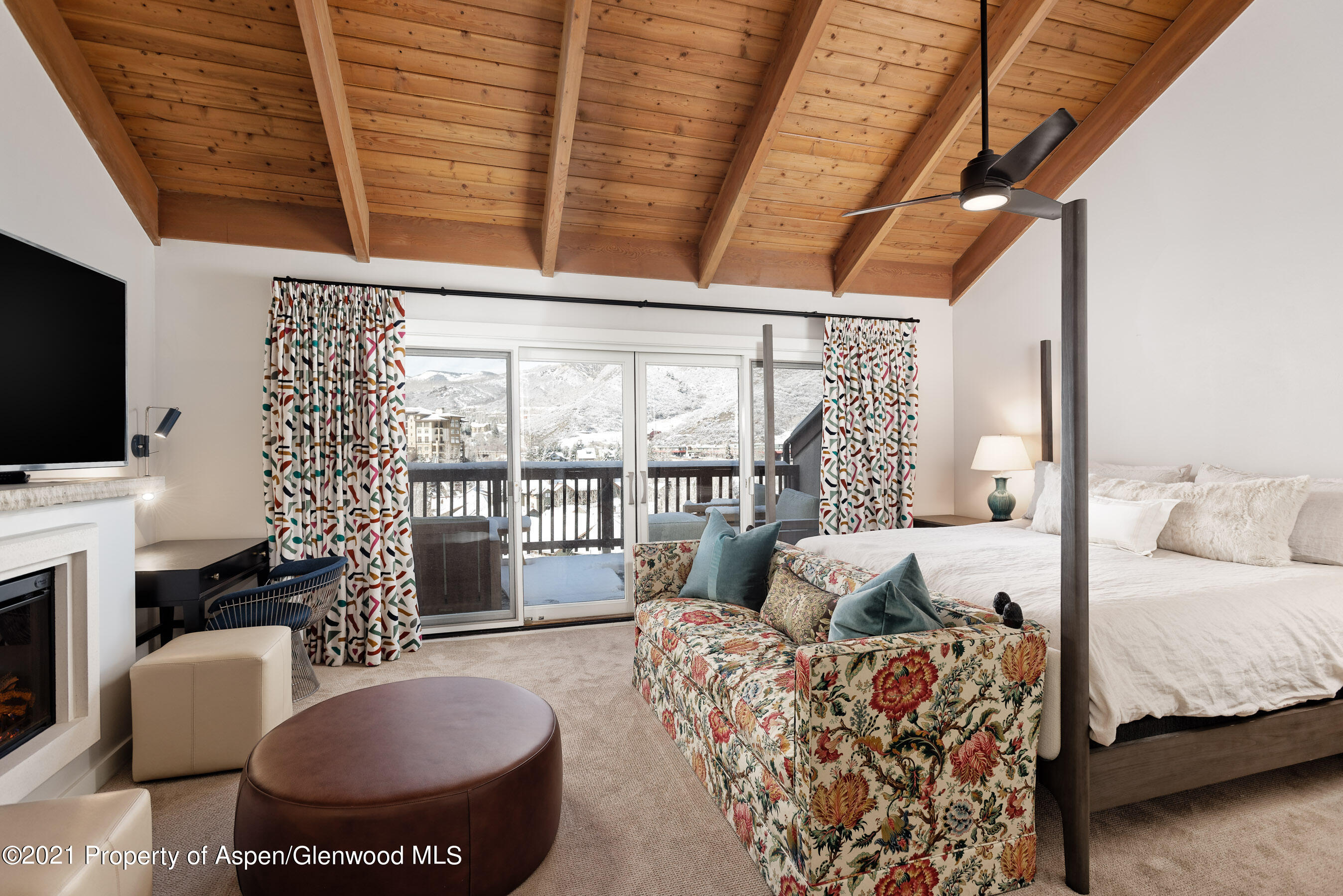 810 Ridge Road, Unit 2 Snowmass Village, CO 81615 - Photo 8 of 31 a living room with furniture a flat screen tv and a large window