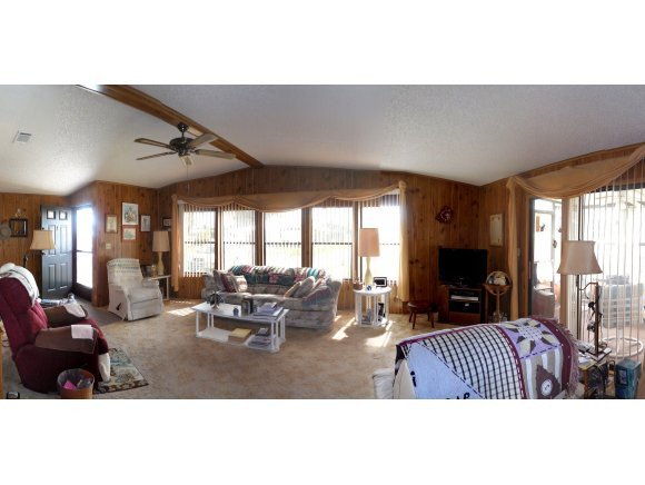 120 Audubon Road Naples, FL 34114 - Photo 2 of 11 a living room with furniture large window and a fireplace