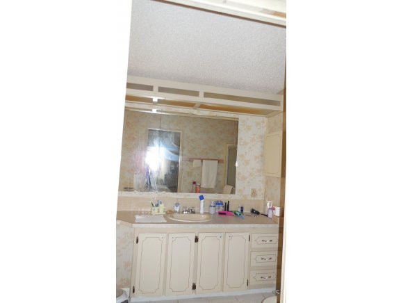 120 Audubon Road Naples, FL 34114 - Photo 8 of 11 a bathroom with a sink and a mirror