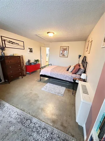 a bedroom with bed and window