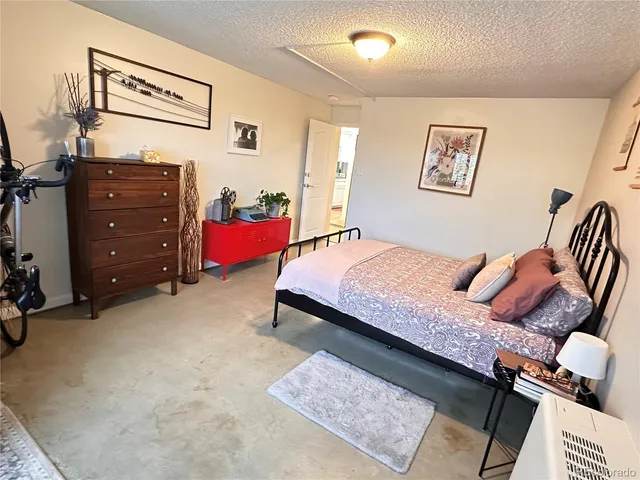 a bedroom with a bed and dresser