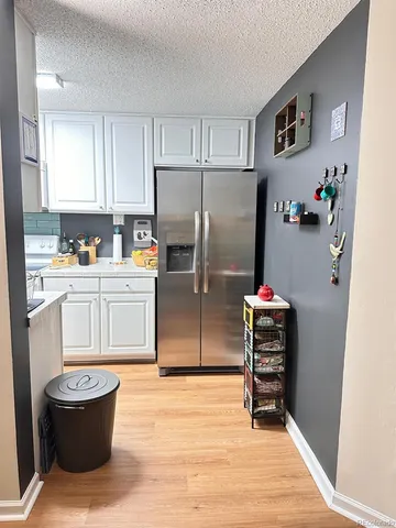 a kitchen with stainless steel appliances a refrigerator sink and cabinets