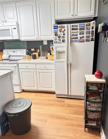 a kitchen with a refrigerator and a stove