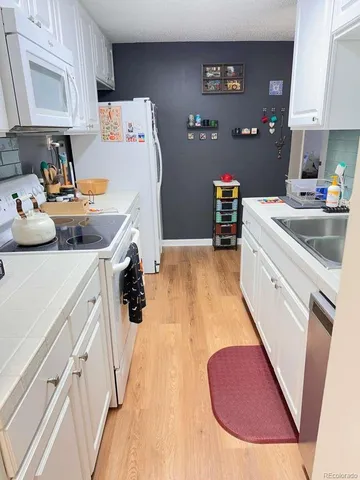 a storage room with furniture and a wooden floor