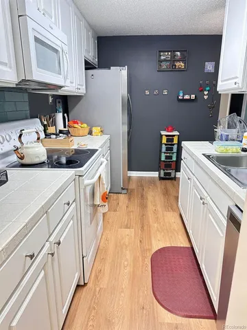 a kitchen with a sink appliances and cabinets