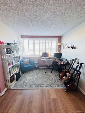 a living room with furniture and a book shelf
