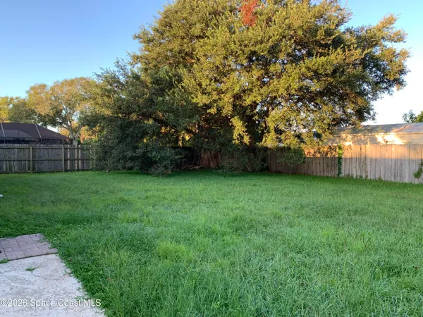 a view of yard with grass and a trees