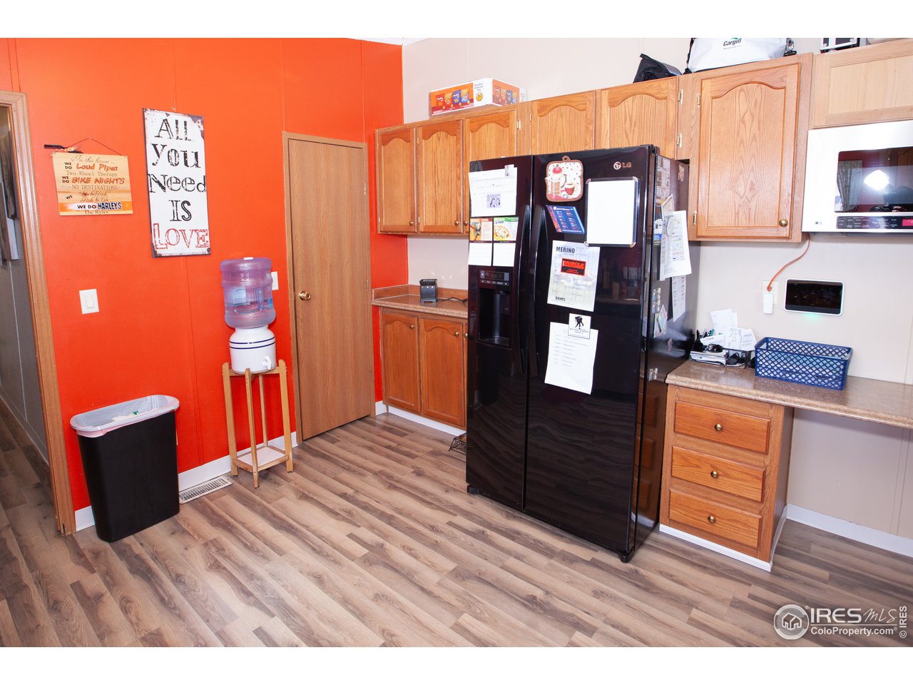 14780 Bluestem Street Sterling, CO 80751 - Photo 12 of 40 a view of a kitchen with stainless steel appliances wooden floor and seating