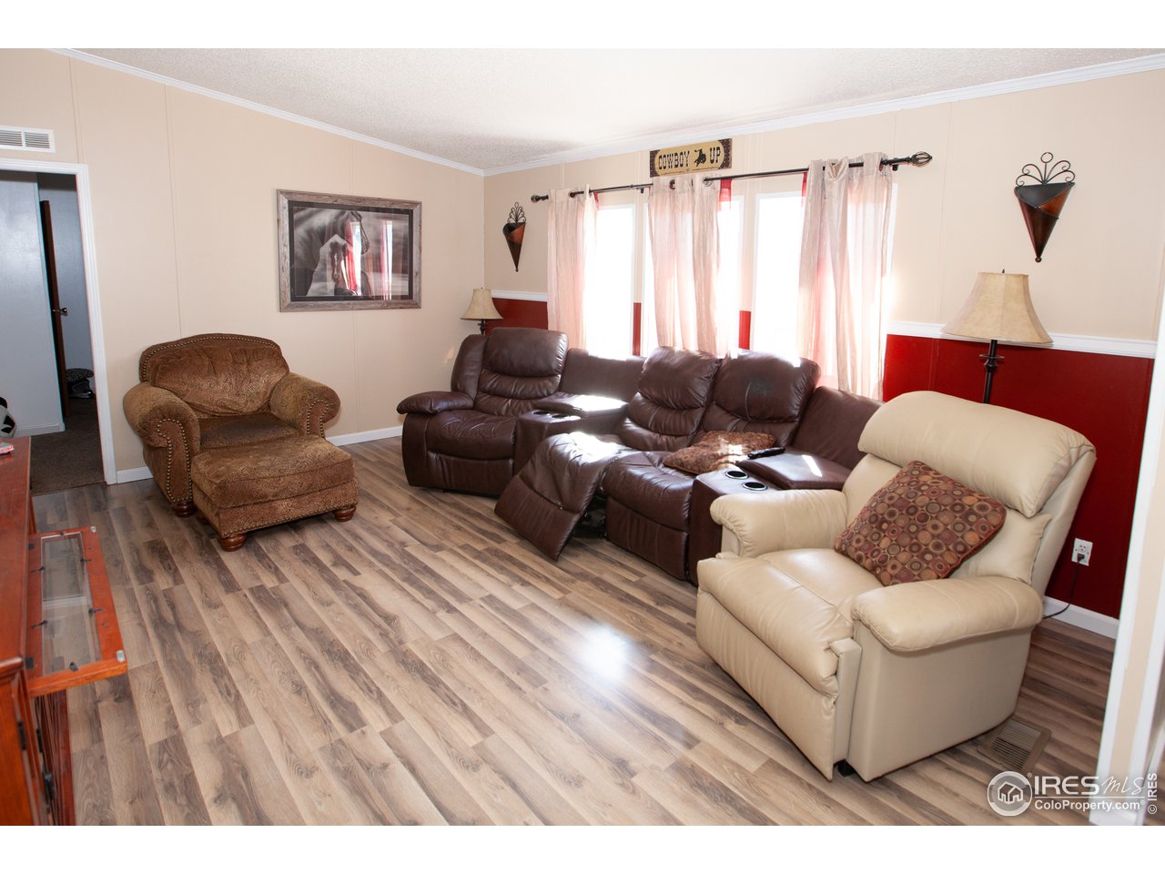 14780 Bluestem Street Sterling, CO 80751 - Photo 14 of 40 a living room with furniture and a large window