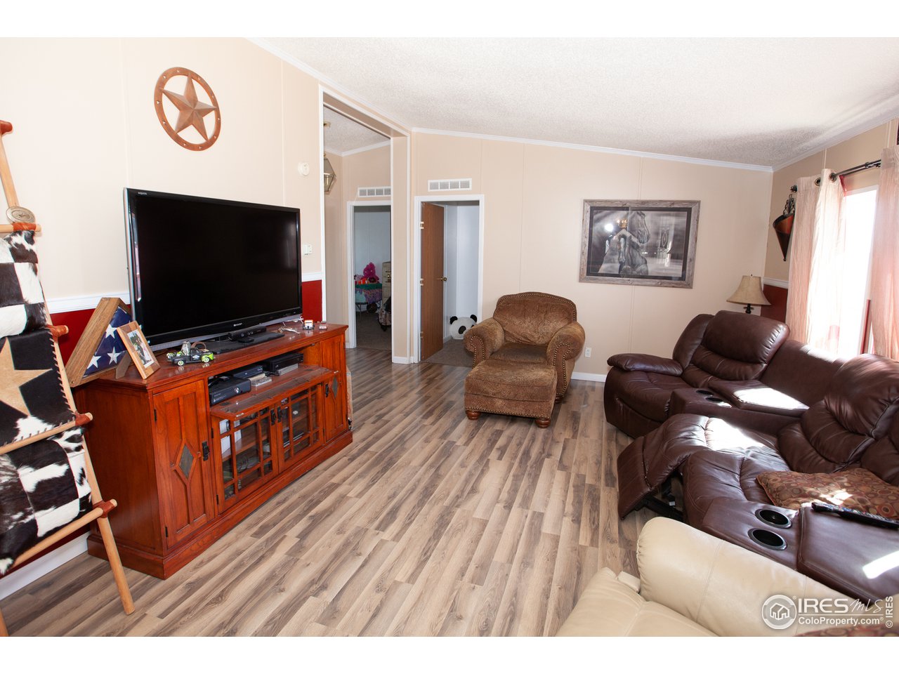 14780 Bluestem Street Sterling, CO 80751 - Photo 15 of 40 a living room with furniture and a flat screen tv