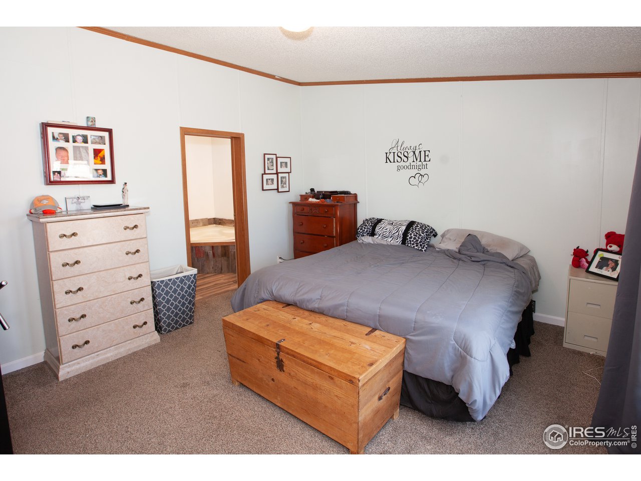 14780 Bluestem Street Sterling, CO 80751 - Photo 19 of 40 a bedroom with a bed and painting on the wall