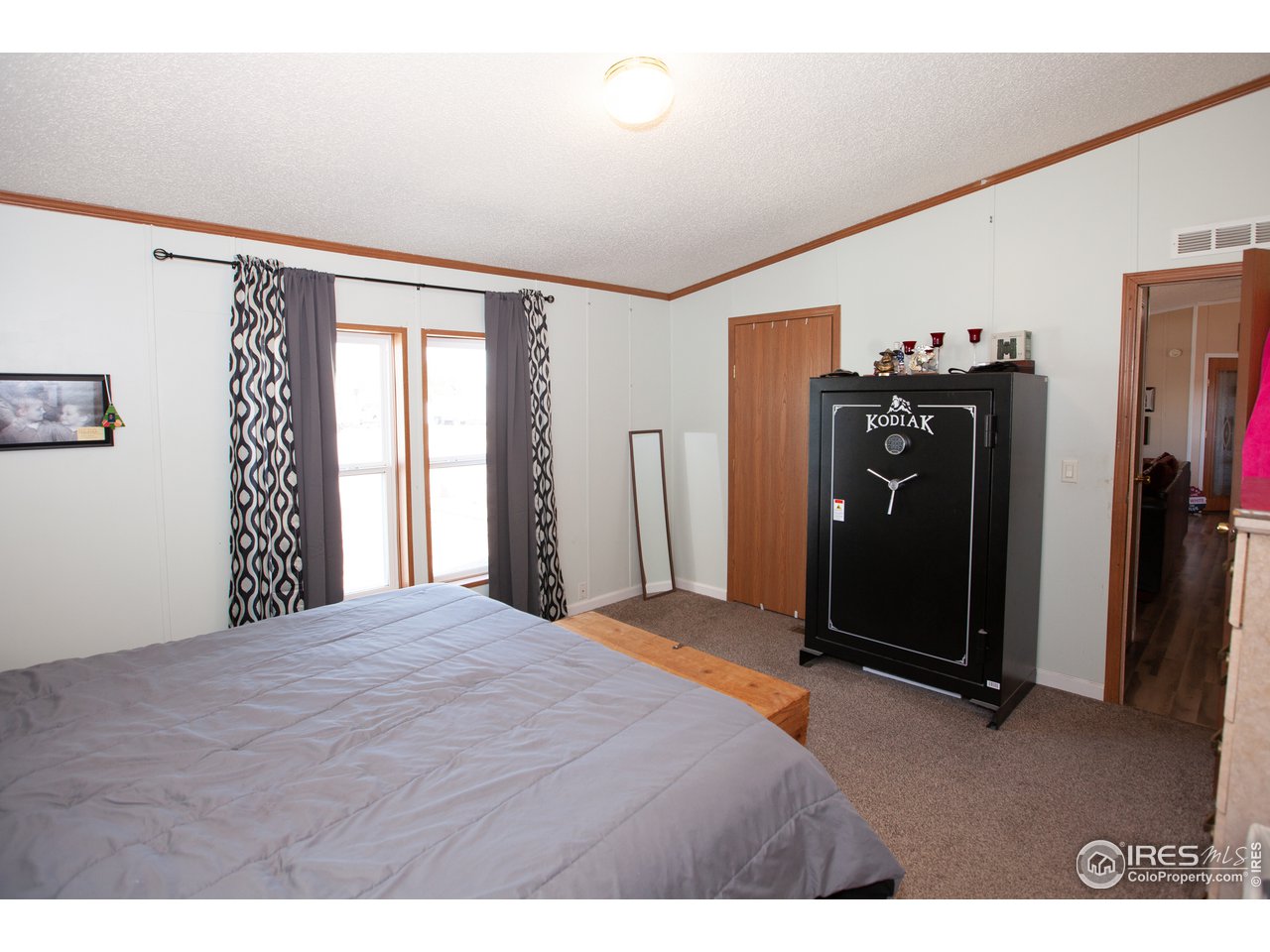 14780 Bluestem Street Sterling, CO 80751 - Photo 21 of 40 a bedroom with a bed and a large window