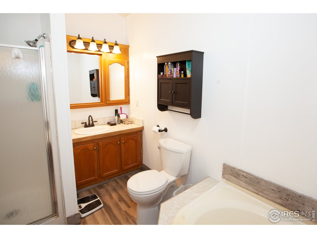 14780 Bluestem Street Sterling, CO 80751 - Photo 22 of 40 a bathroom with a toilet sink a mirror and vanity