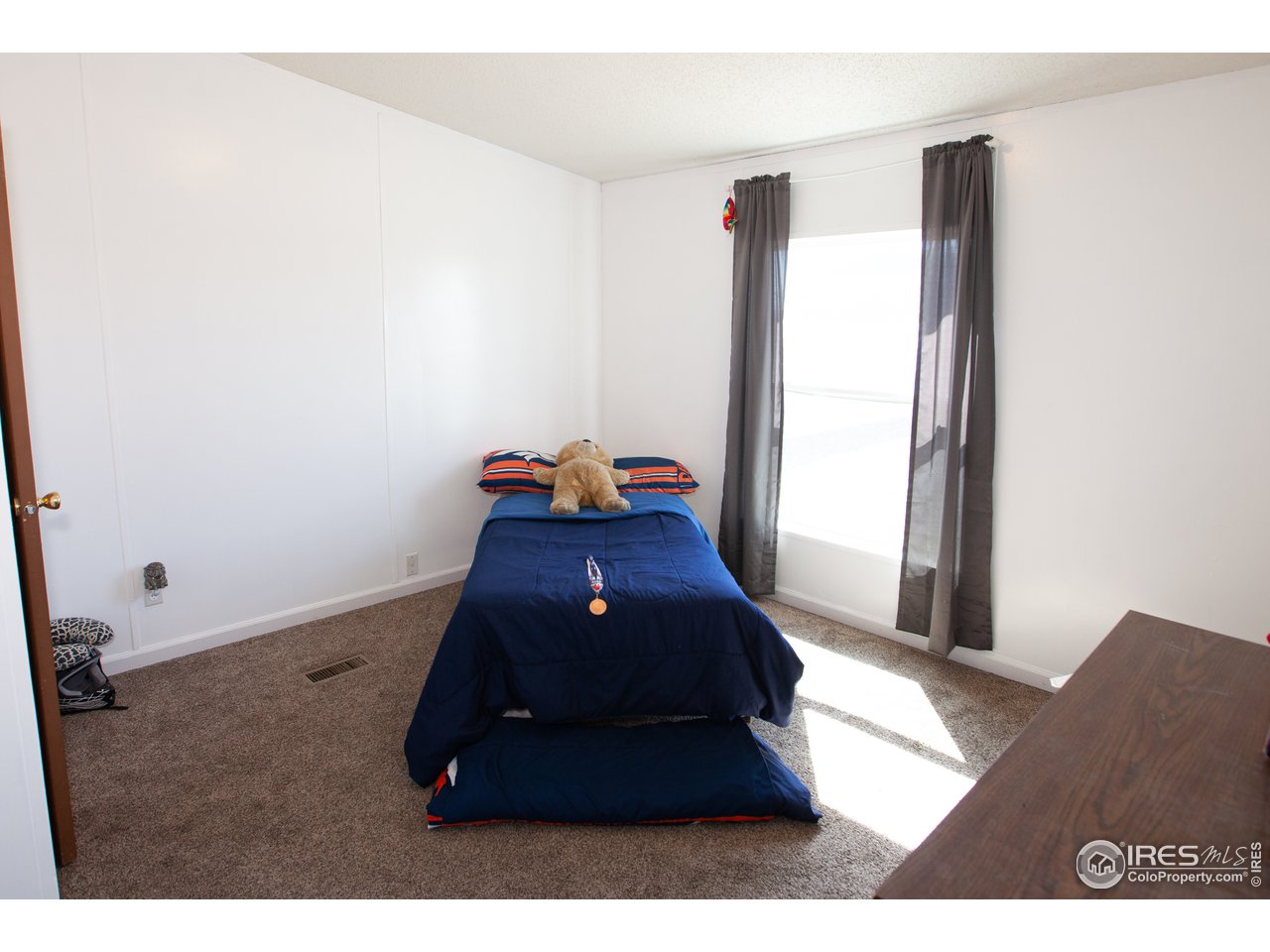 14780 Bluestem Street Sterling, CO 80751 - Photo 23 of 40 a room with a bed and a large window
