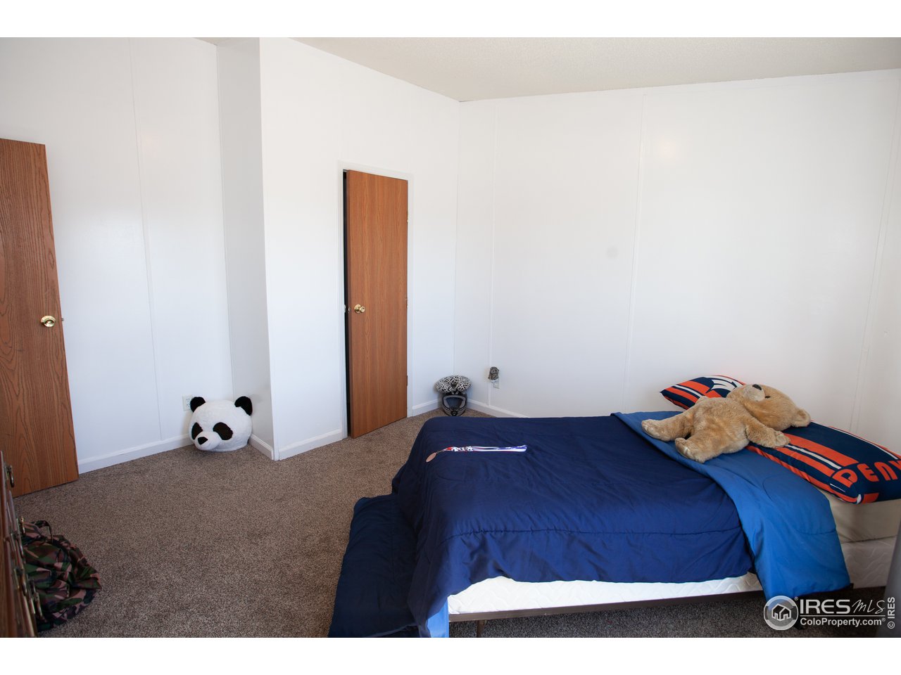 14780 Bluestem Street Sterling, CO 80751 - Photo 24 of 40 a bedroom with a bed and cabinets