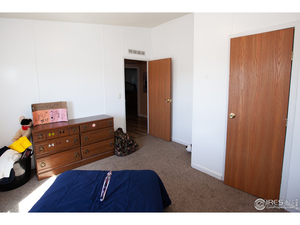 14780 Bluestem Street Sterling, CO 80751 - Photo 25 of 40 a room with a dresser and a window