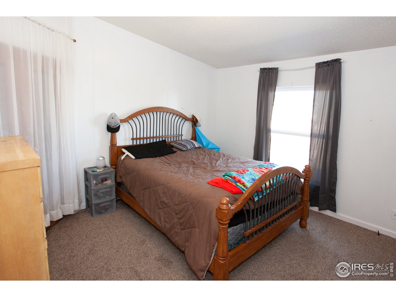 14780 Bluestem Street Sterling, CO 80751 - Photo 26 of 40 a bedroom with a bed and a window