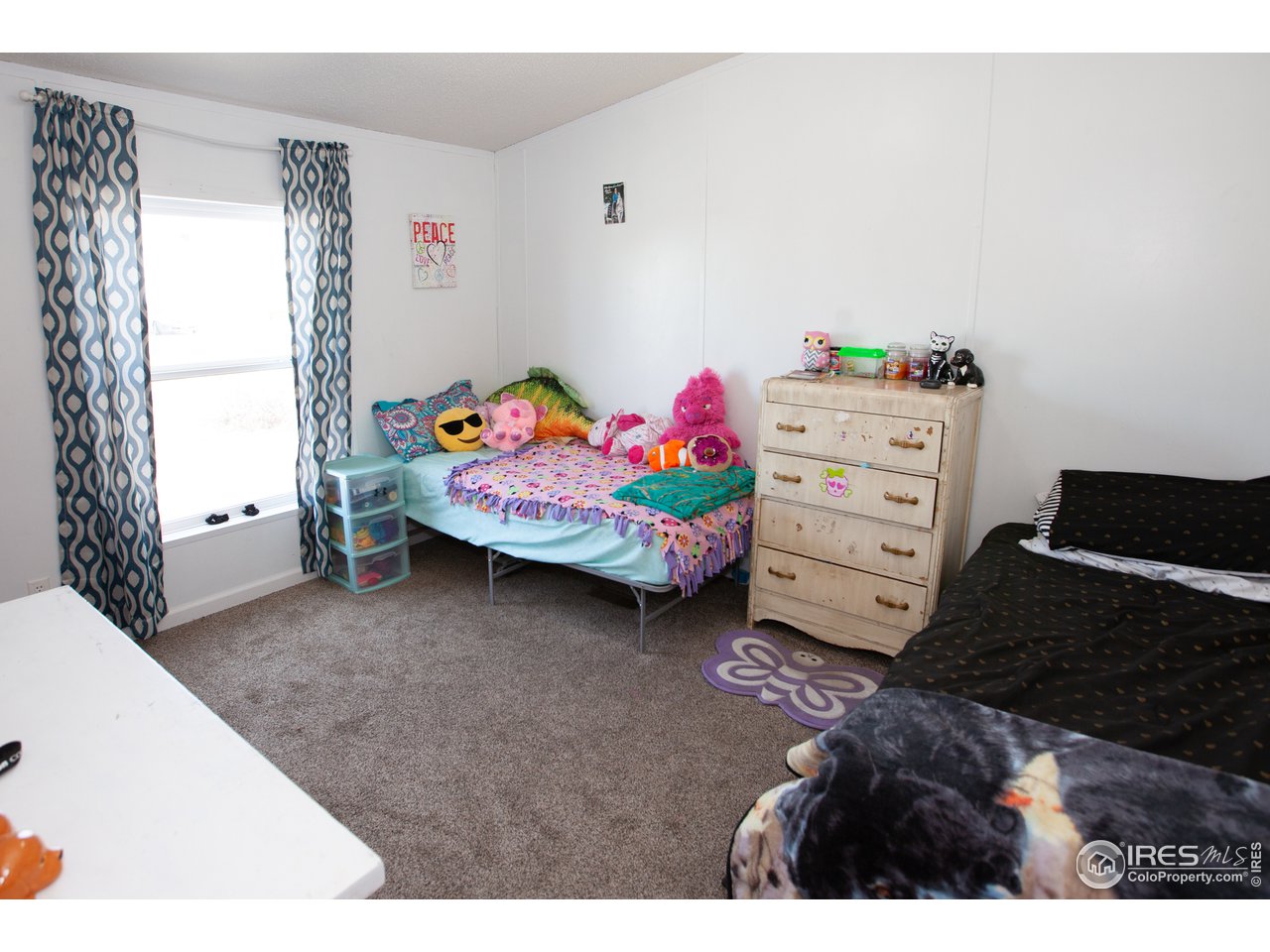 14780 Bluestem Street Sterling, CO 80751 - Photo 30 of 40 a bedroom with a bed and a window