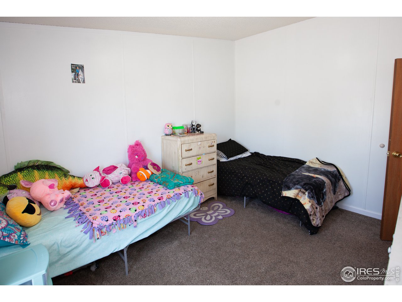 14780 Bluestem Street Sterling, CO 80751 - Photo 32 of 40 a bedroom with a bed and dresser