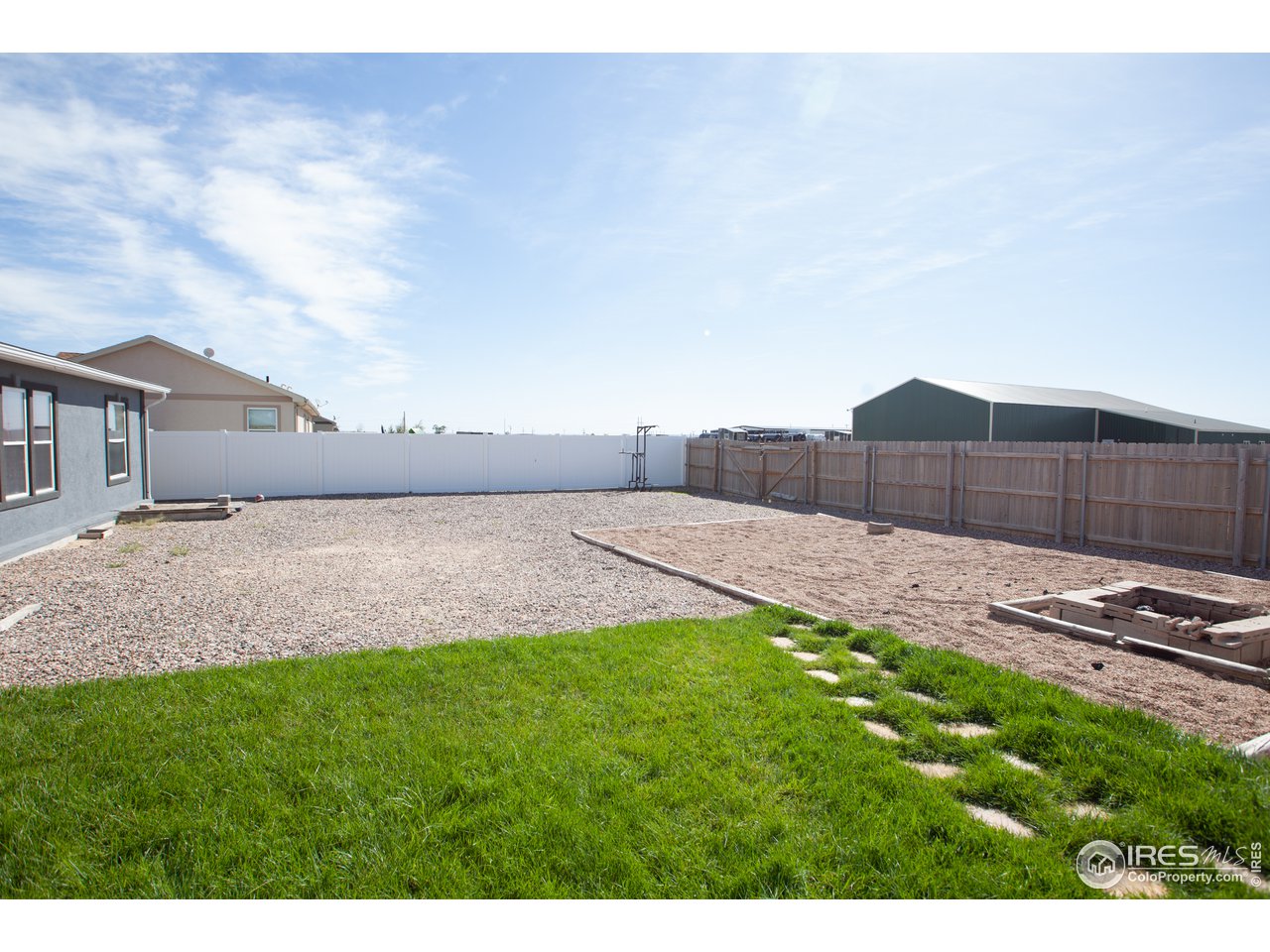 14780 Bluestem Street Sterling, CO 80751 - Photo 35 of 40 a backyard of a house with lots of green space