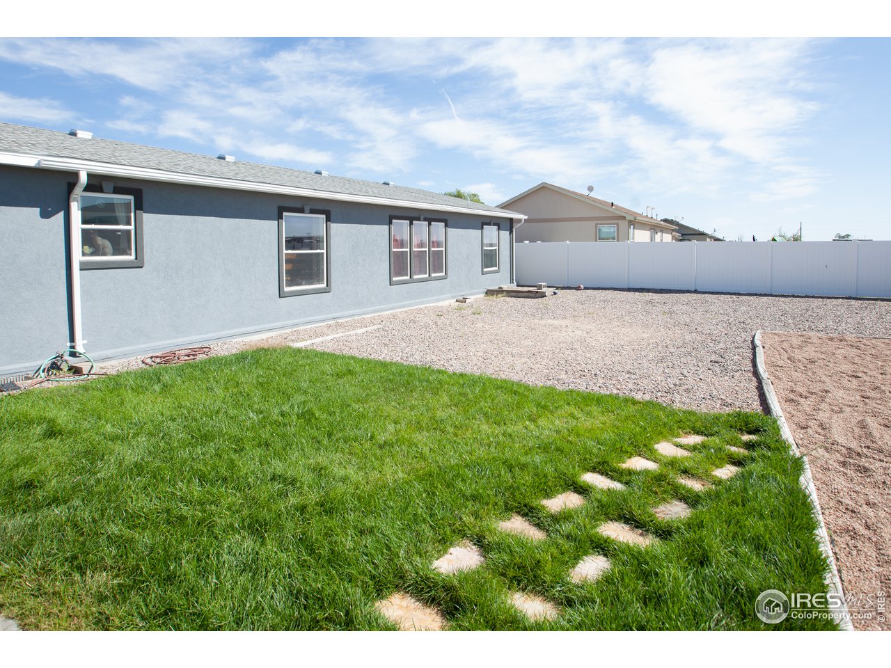 14780 Bluestem Street Sterling, CO 80751 - Photo 36 of 40 a front view of house with yard and green space
