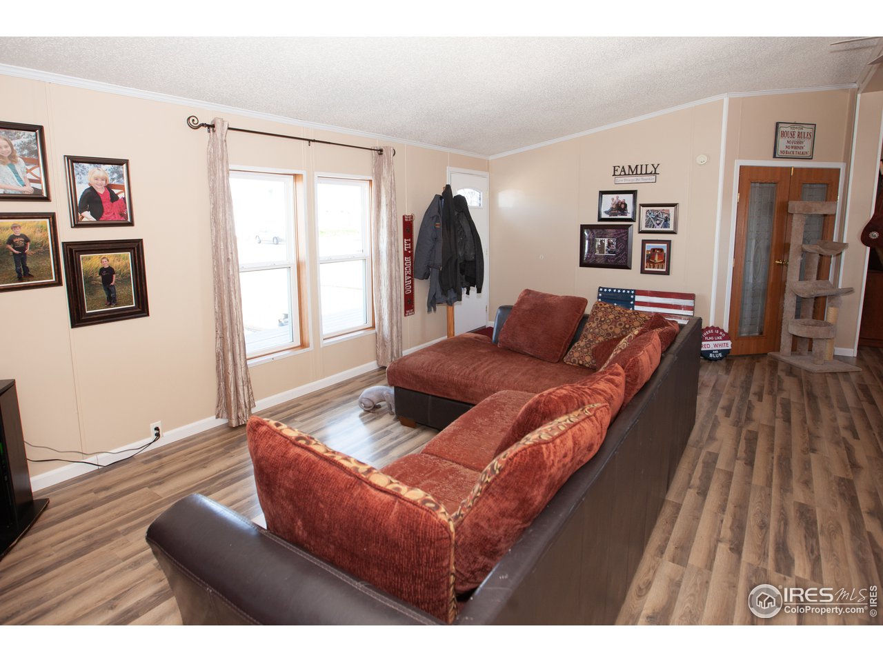 14780 Bluestem Street Sterling, CO 80751 - Photo 6 of 40 a living room with furniture and wooden floor