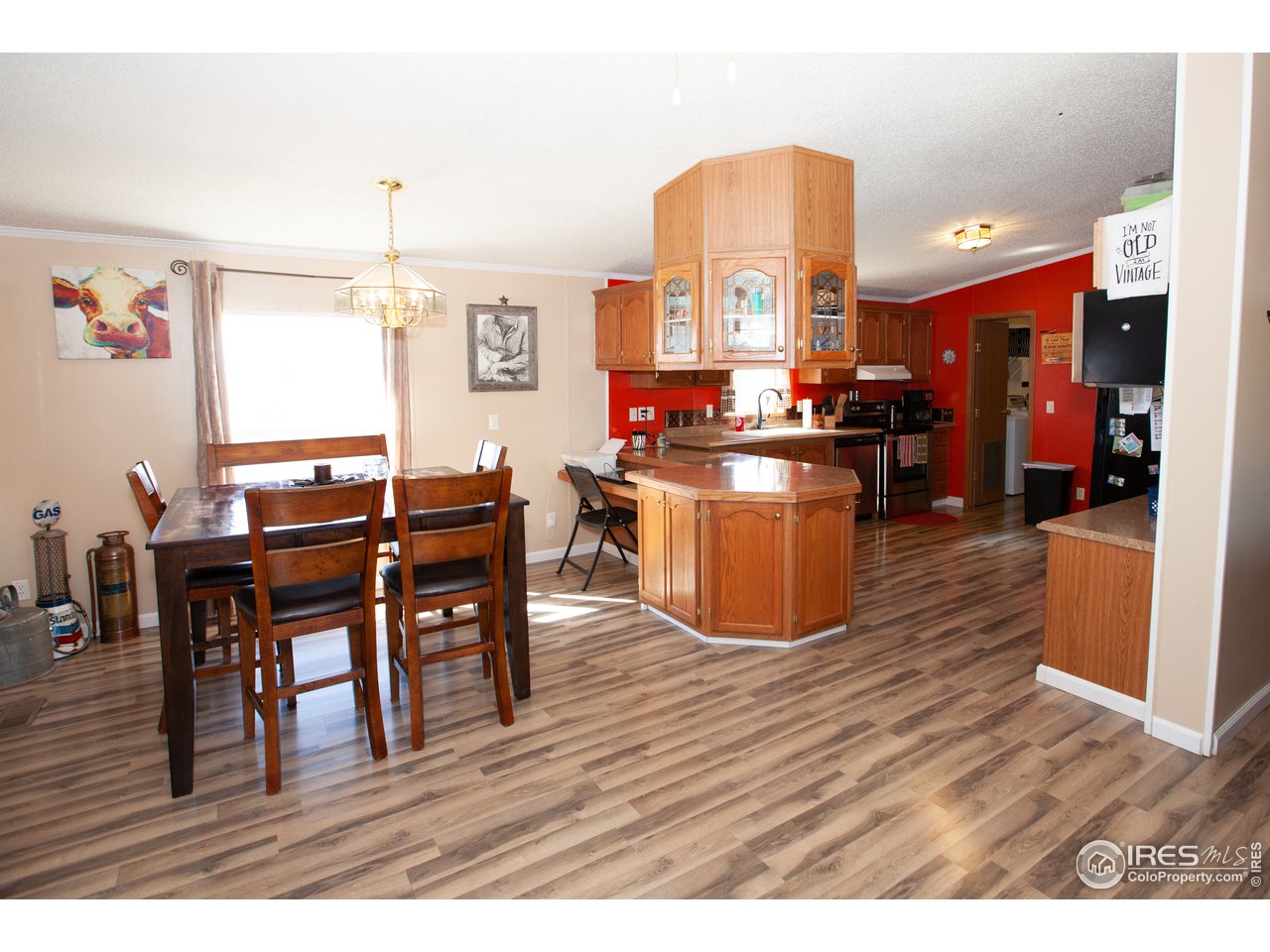 14780 Bluestem Street Sterling, CO 80751 - Photo 7 of 40 a kitchen with stainless steel appliances granite countertop a stove top oven a sink dishwasher and a dining table with kitchen view