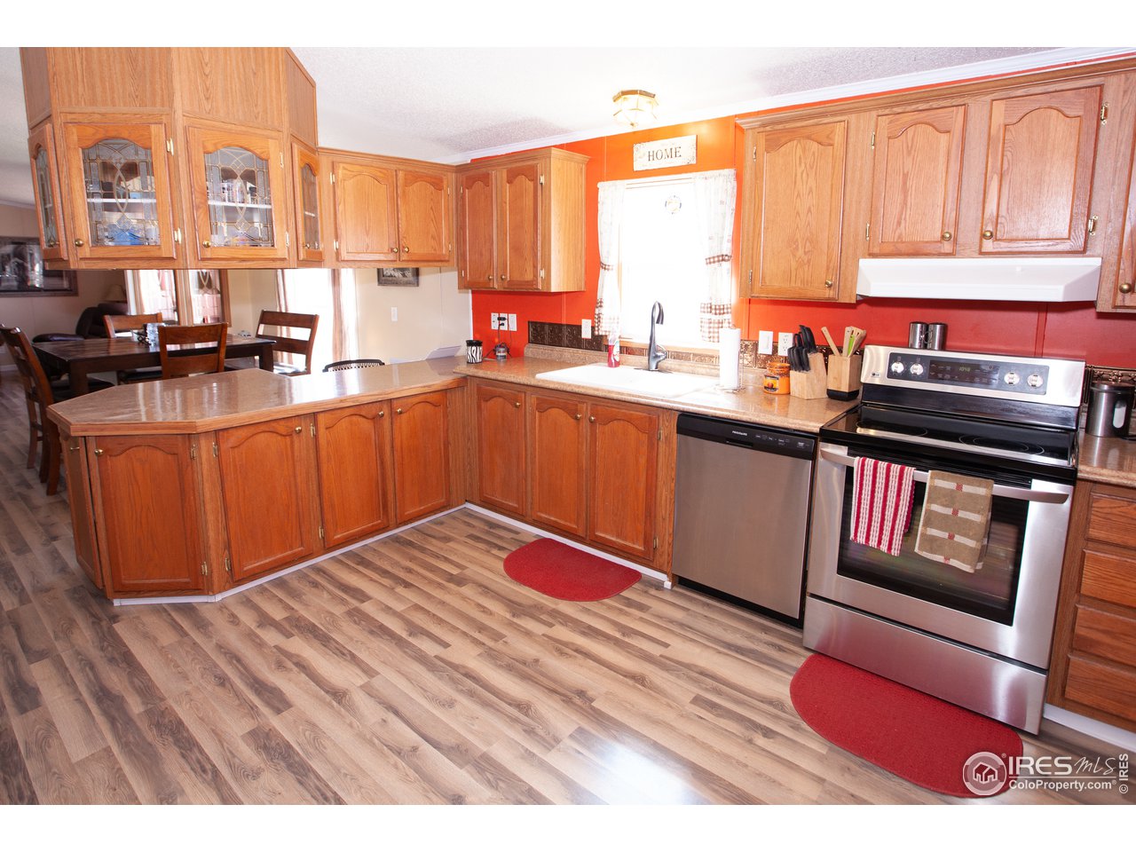 14780 Bluestem Street Sterling, CO 80751 - Photo 10 of 40 a kitchen with stainless steel appliances granite countertop a stove a sink and a microwave