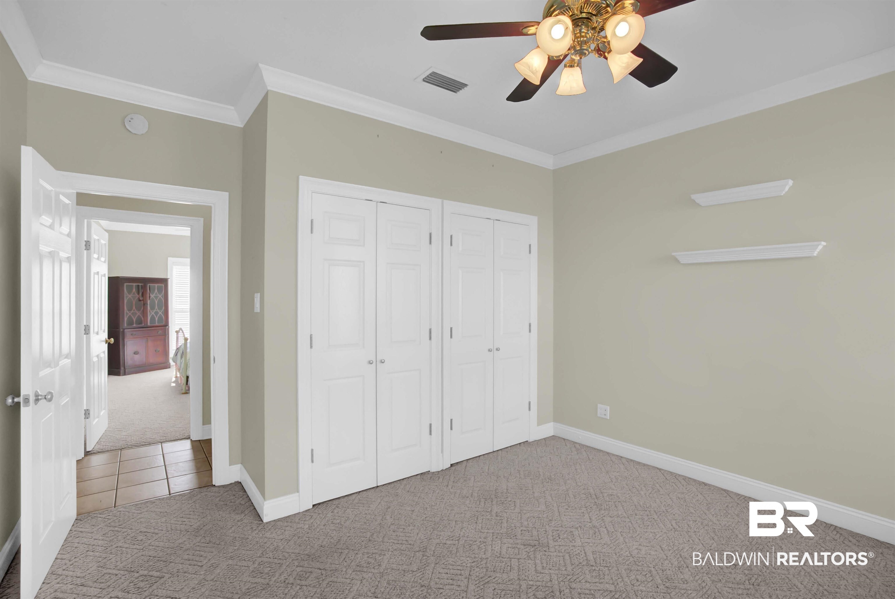 27688 Rigsby Road Daphne, AL 36526 - Photo 36 of 56 Unfurnished bedroom with ceiling fan, crown molding, carpet flooring, and multiple closets