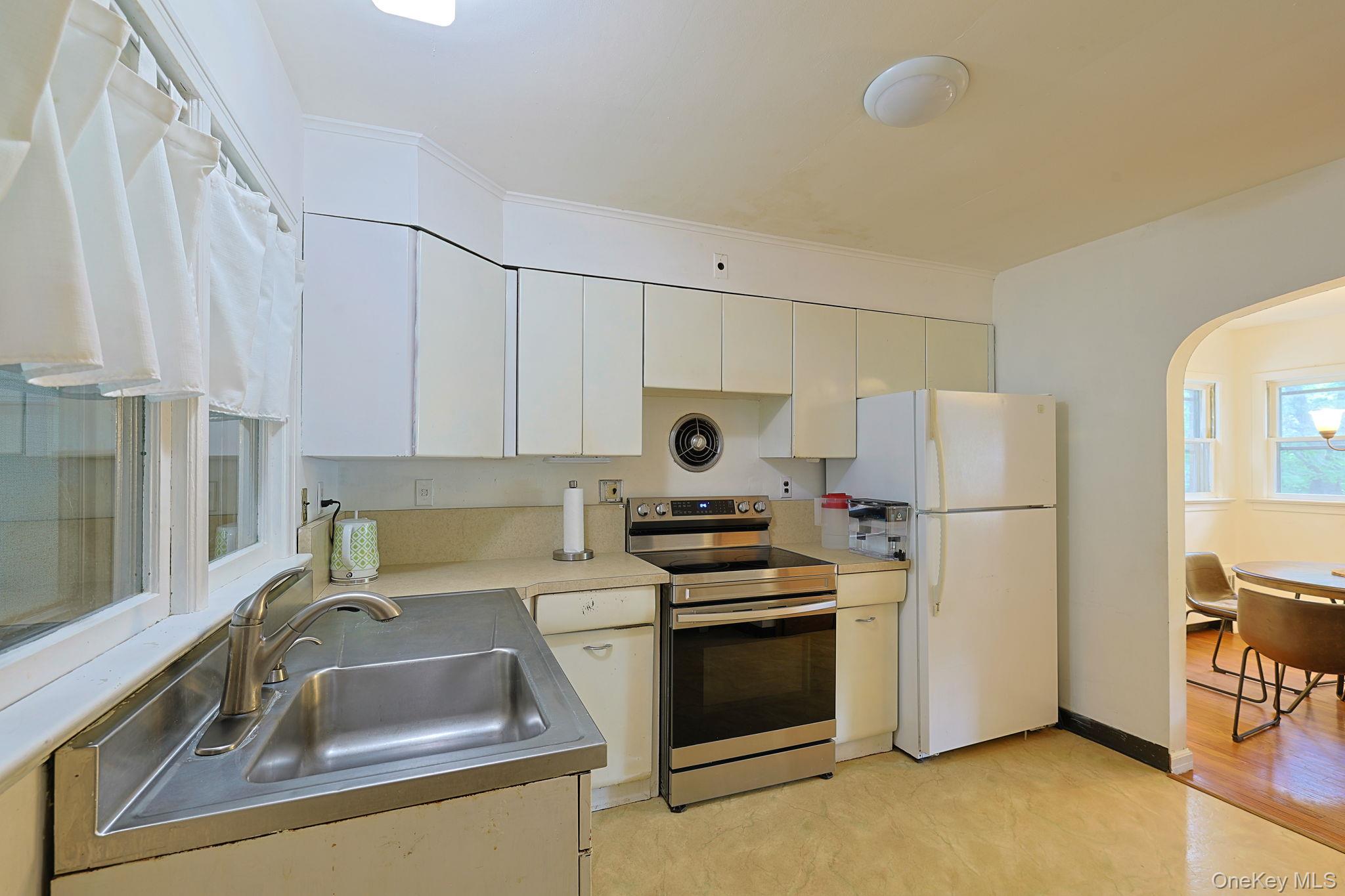 178 Mt Airy Road New Windsor, NY 12553 - Photo 9 of 31 a kitchen with refrigerator a sink a stove and white cabinets