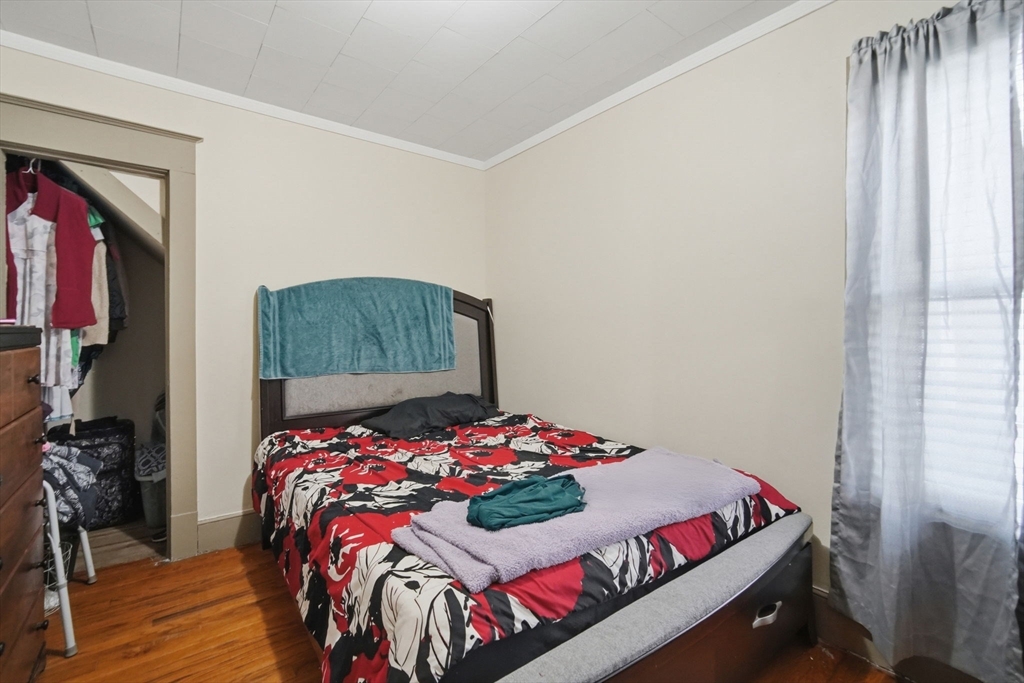 102-104 Cambridge Street Springfield, MA 01109 - Photo 6 of 38 a bedroom with a bed and a window