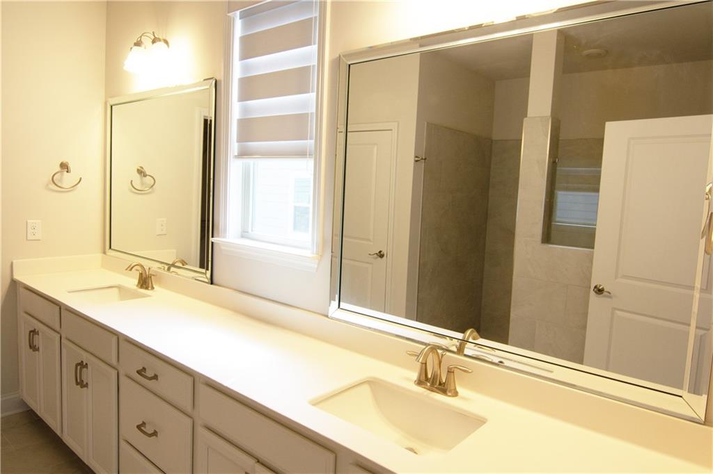 2472 Knob Crk Road Snellville, GA 30078 - Photo 11 of 30 a bathroom with a granite countertop sink and a mirror