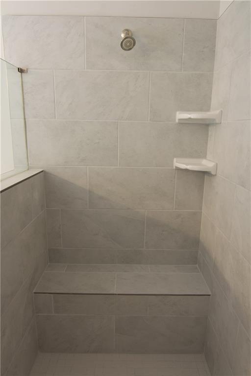 2472 Knob Crk Road Snellville, GA 30078 - Photo 12 of 30 a bathroom with a glass shower door