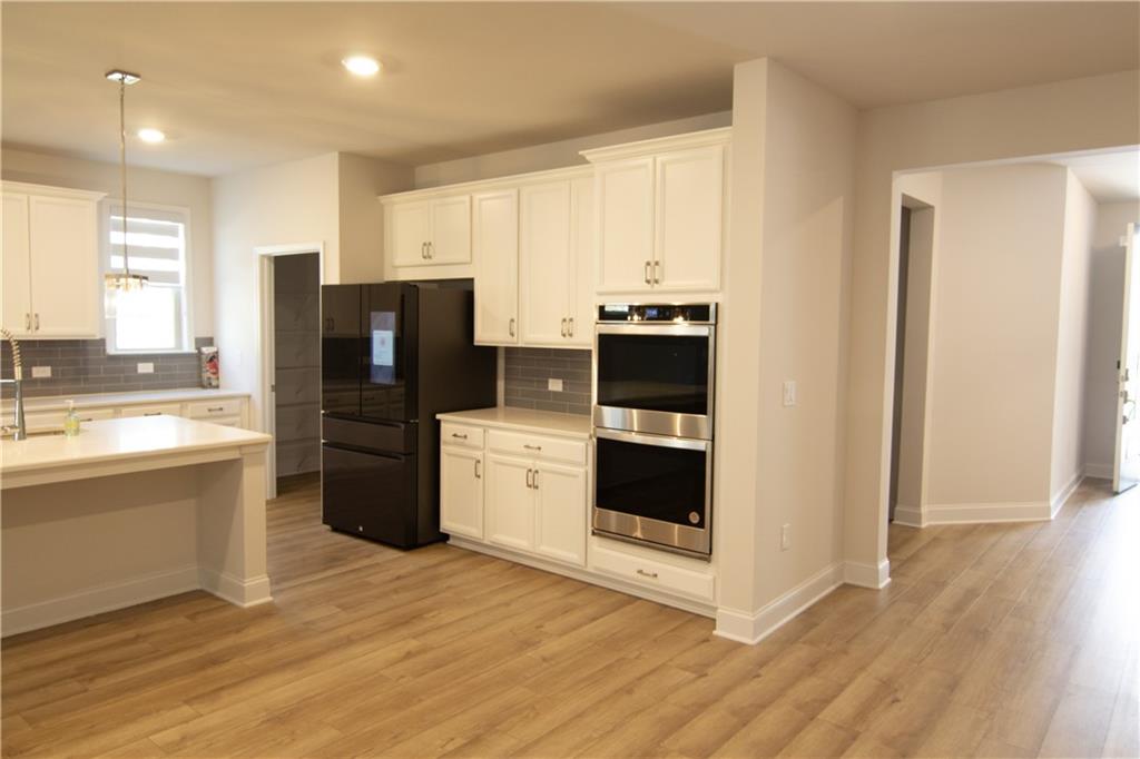 2472 Knob Crk Road Snellville, GA 30078 - Photo 4 of 30 a kitchen with stainless steel appliances a refrigerator stove and sink