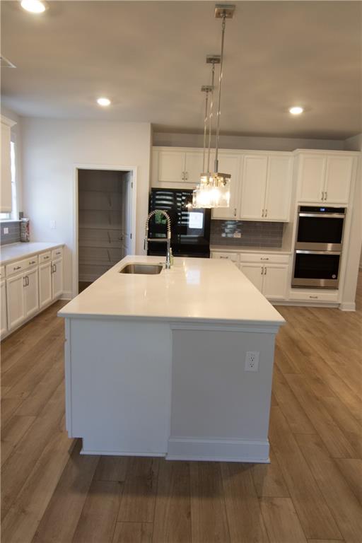 2472 Knob Crk Road Snellville, GA 30078 - Photo 5 of 30 a room with wooden floors and kitchen view