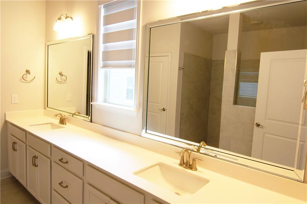 2472 Knob Crk Road Snellville, GA 30078 - Photo 10 of 30 a bathroom with a granite countertop sink and a mirror