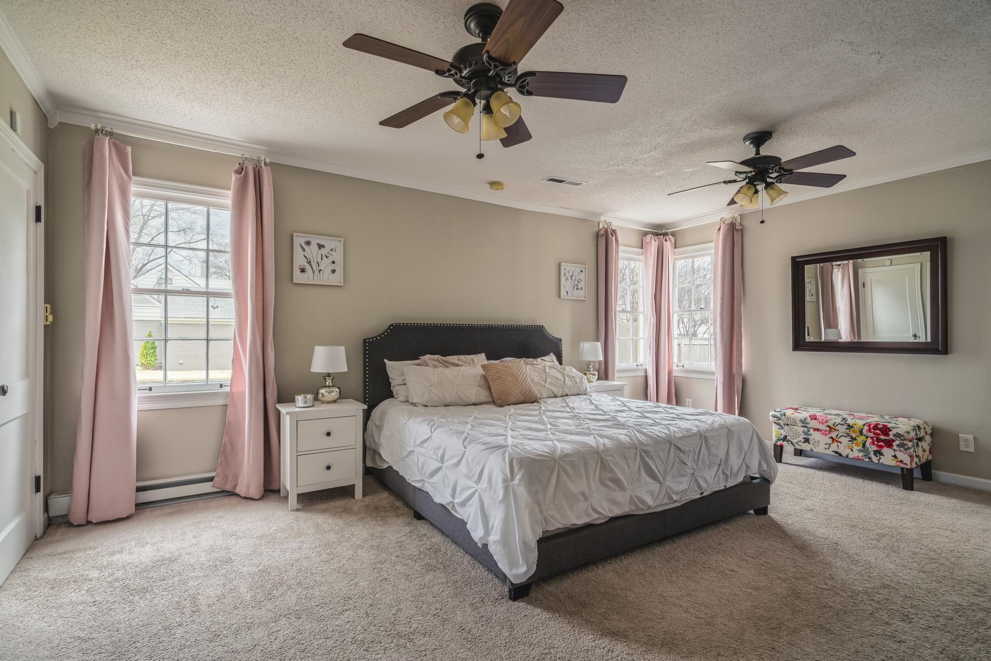 4518 Sequoia Road Memphis, TN 38117 - Photo 12 of 25 a bedroom with a bed and a chandelier