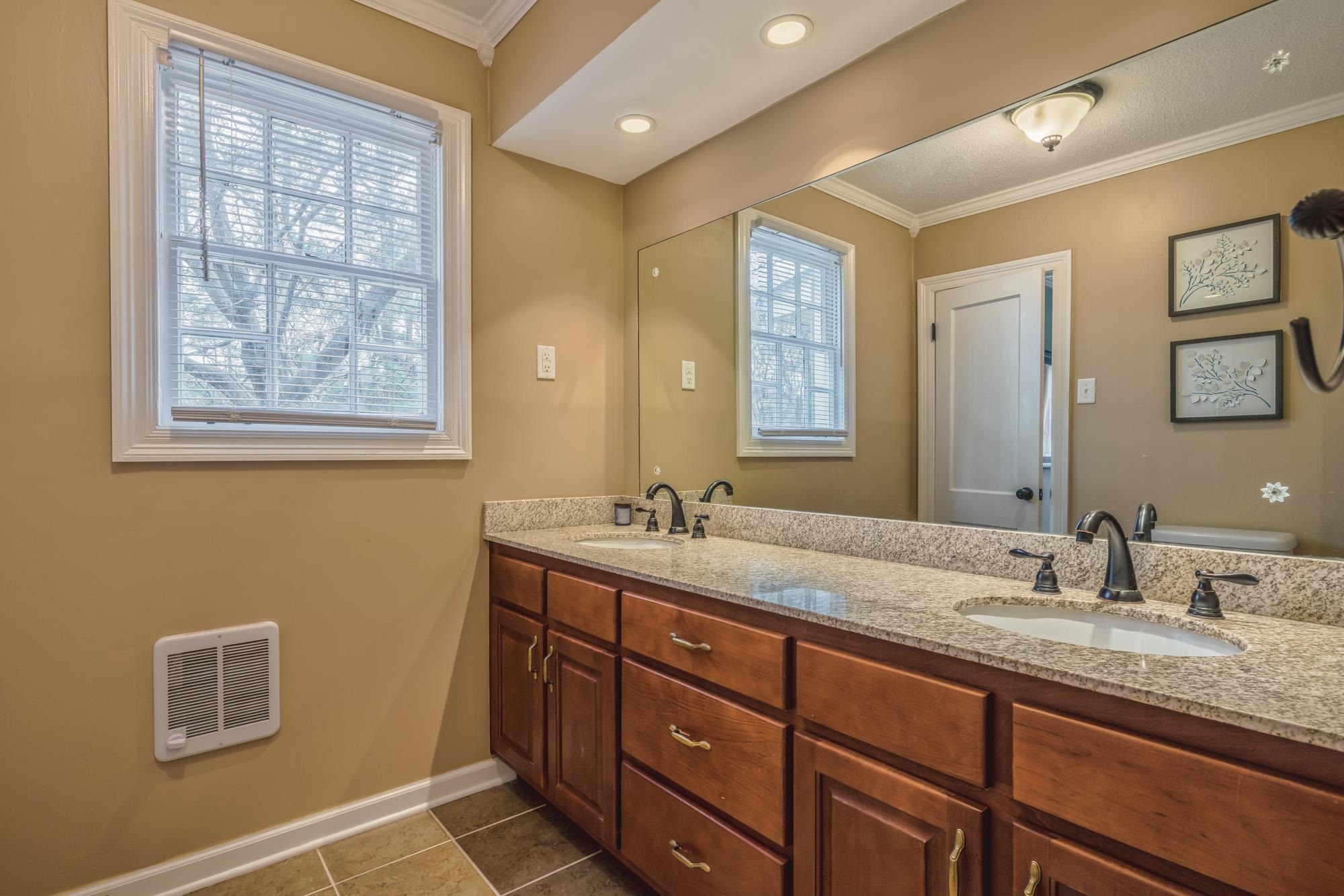 4518 Sequoia Road Memphis, TN 38117 - Photo 13 of 25 a bathroom with double sink and a mirror